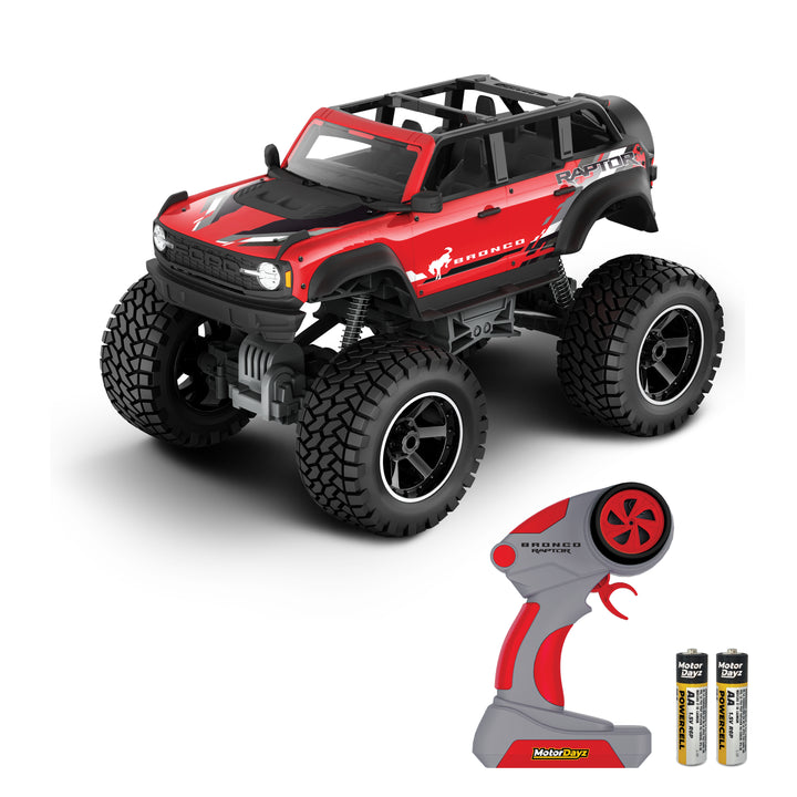 Red and black toy monster truck with remote control and battery on a white background