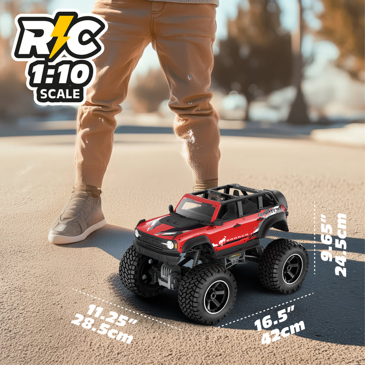 Red and black RC model truck on a road with a person standing nearby, showing scale dimensions.