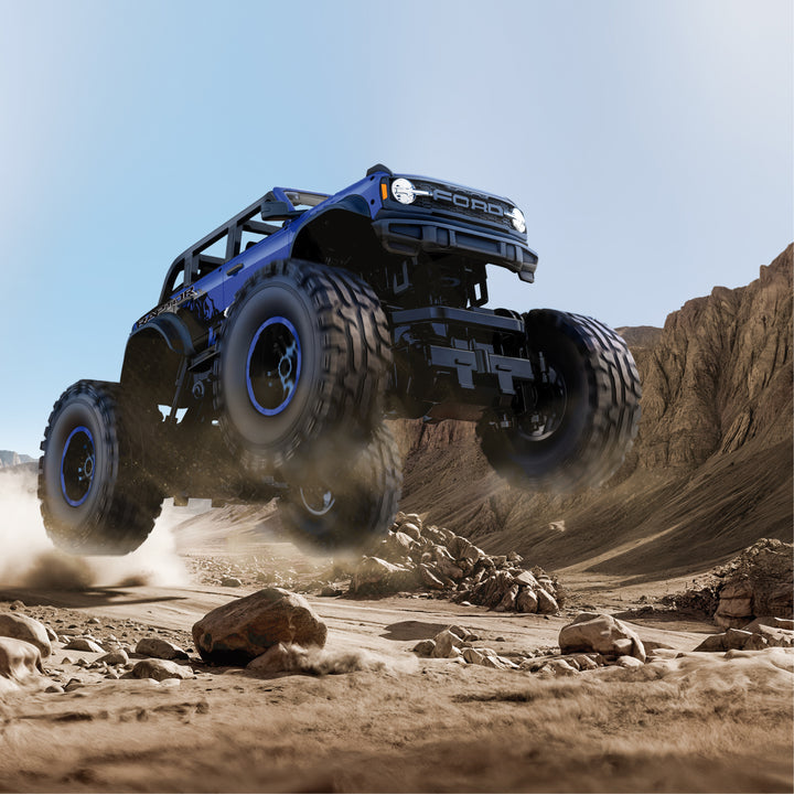 Blue monster truck on a rocky desert landscape