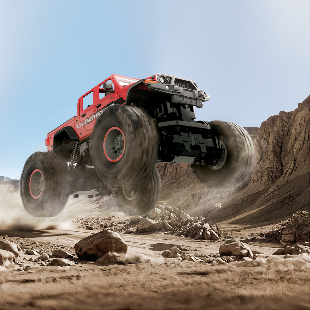 Monster truck in a desert landscape with rocky terrain