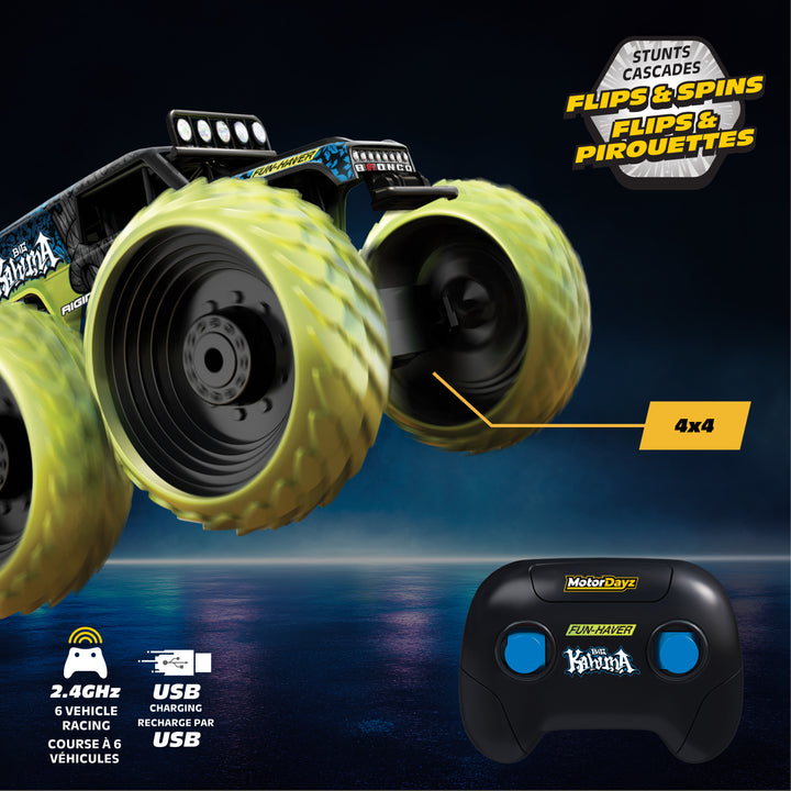 Toy monster truck with large wheels and remote control on a dark background