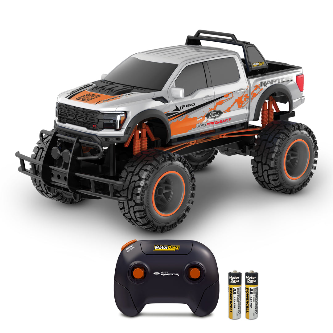 Remote control toy truck with large wheels and a controller on a white background