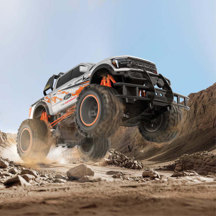 Monster truck in mid-air over a rocky desert landscape