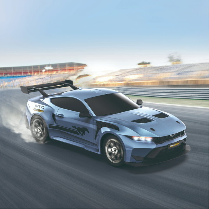 Blue sports car on a racetrack with blurred background