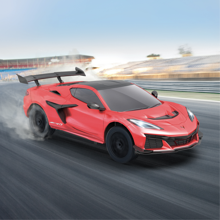Red sports car on a racetrack with a blurred background