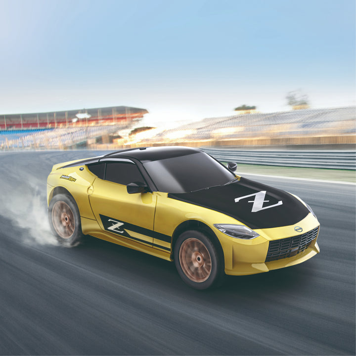 Yellow sports car with a black roof on a racetrack