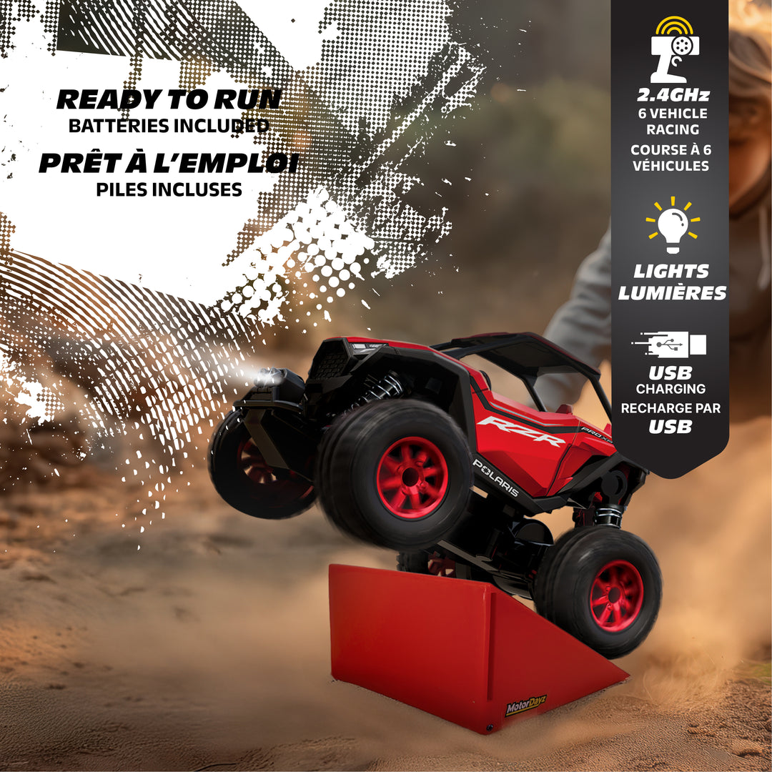 Red remote control car on a dirt track with features highlighted on the right side.