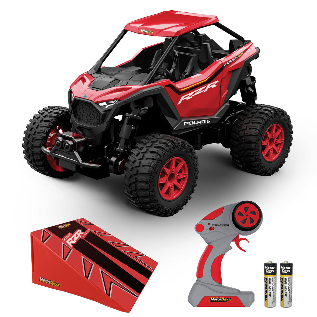 Red toy off-road vehicle with remote control and batteries on a white background